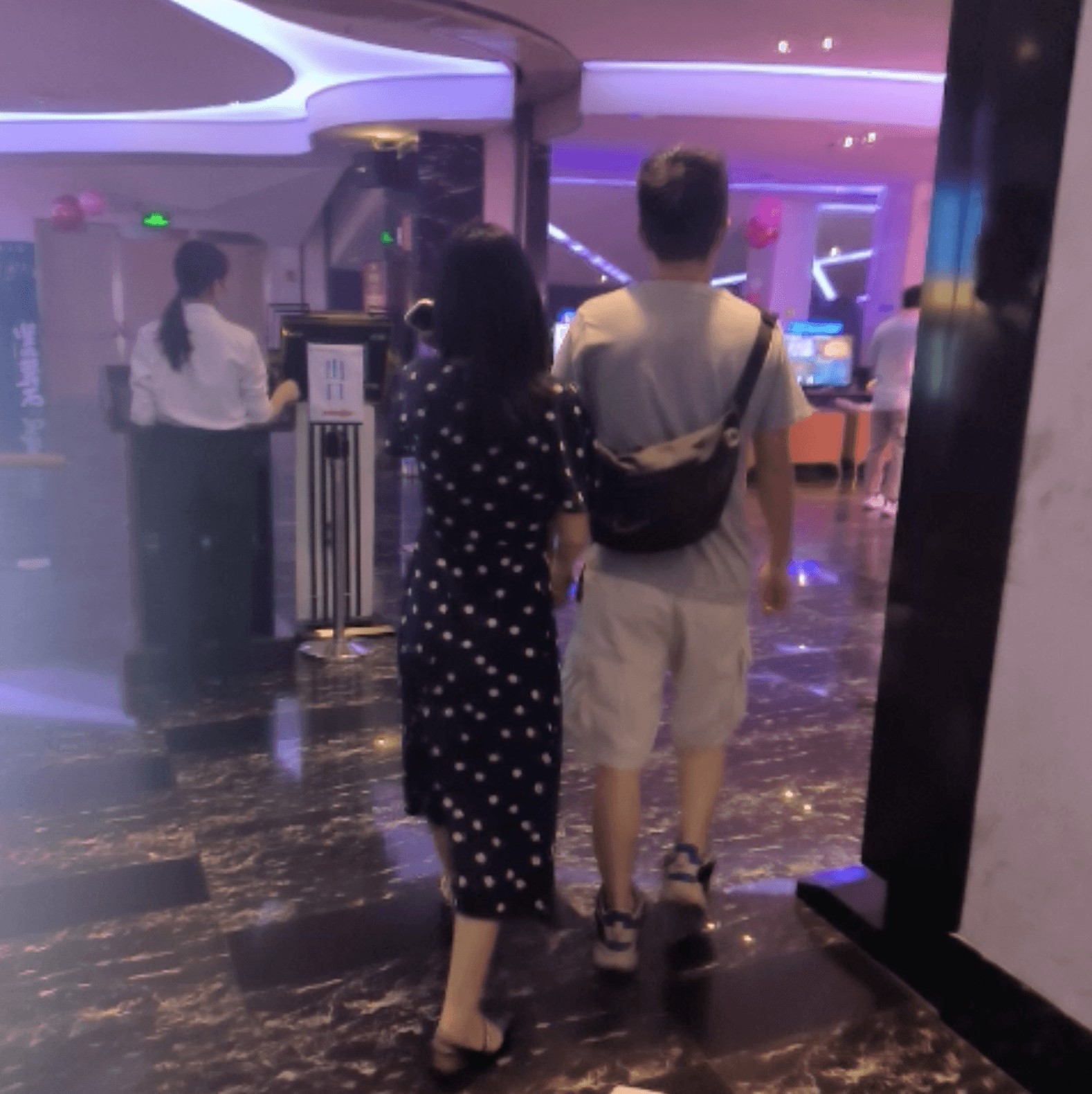 Cinema girl candid stepping on hand with black leather shoes + flat sandals