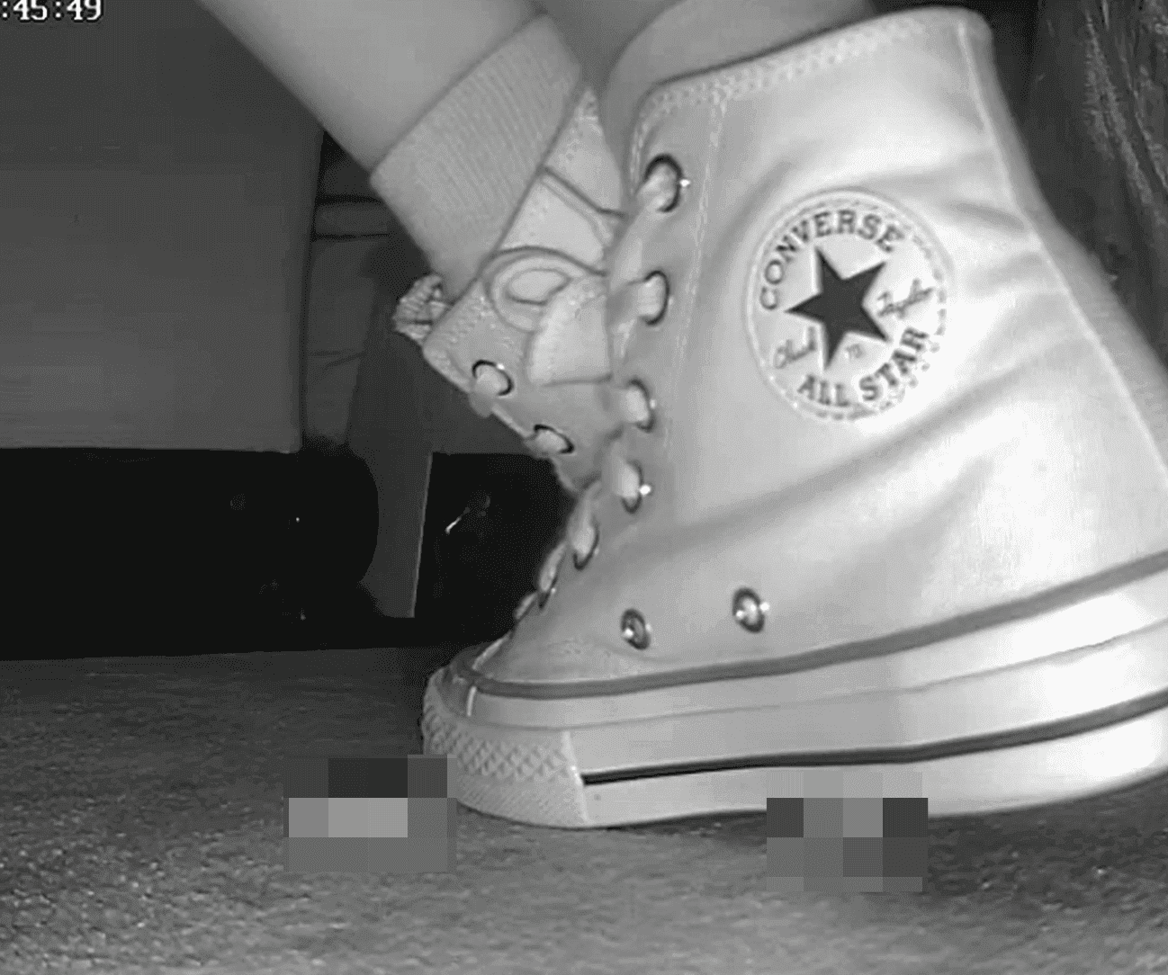 Woman candid crush with high-top white Converse at cinema