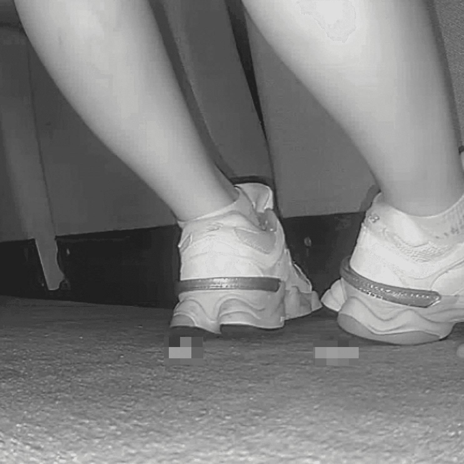 Woman sitting with her boyfriend candid crush with New Balance sneakers at cinema