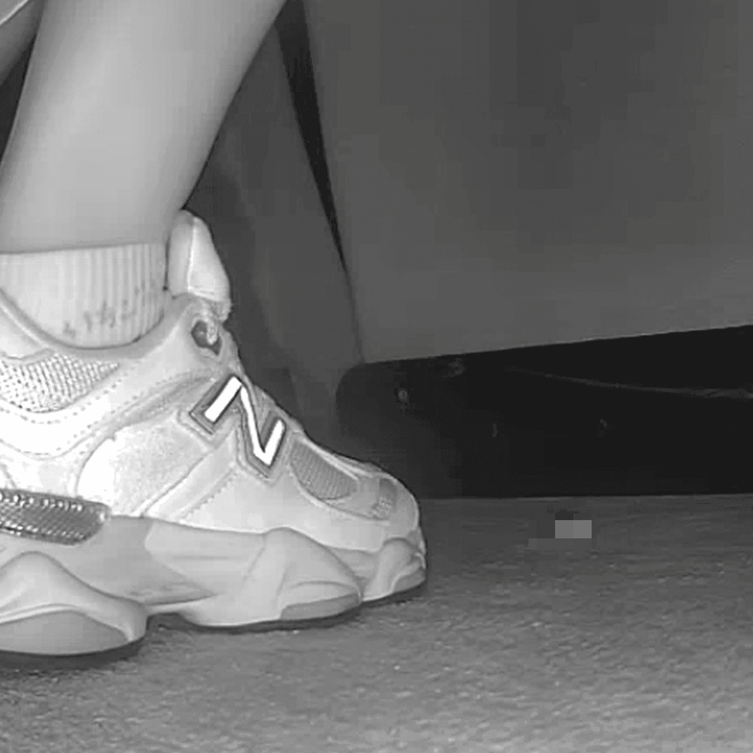 Woman sitting with her boyfriend candid crush with New Balance sneakers at cinema