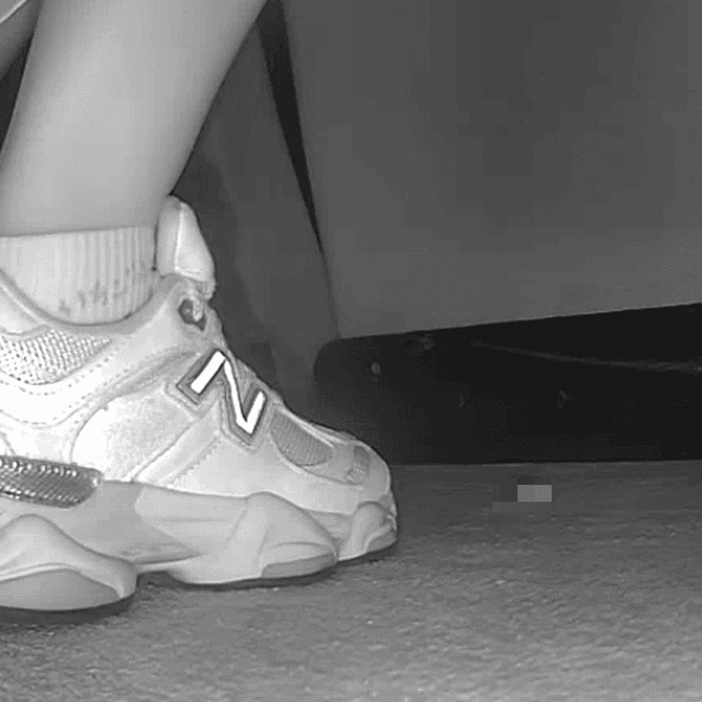 Woman sitting with her boyfriend candid crush with New Balance sneakers at cinema