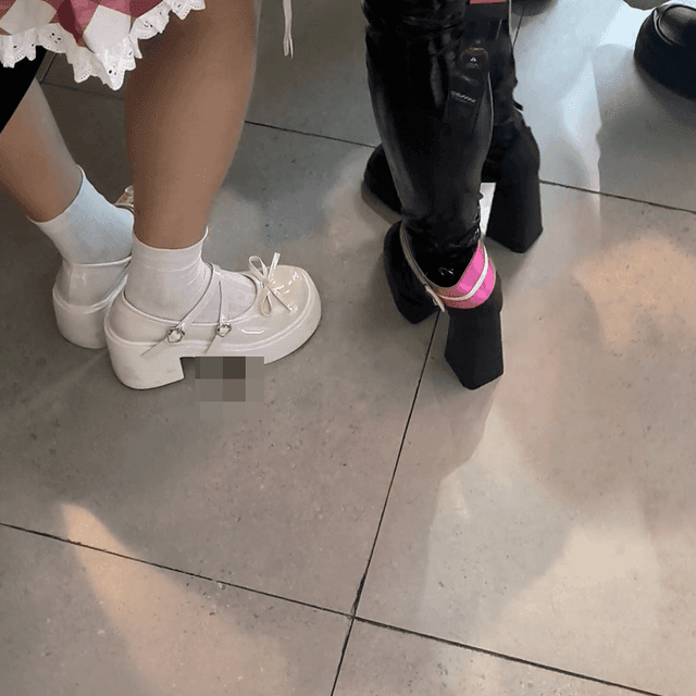 Game arcade woman candid crush with chunky heeled leather shoes and Martin boots