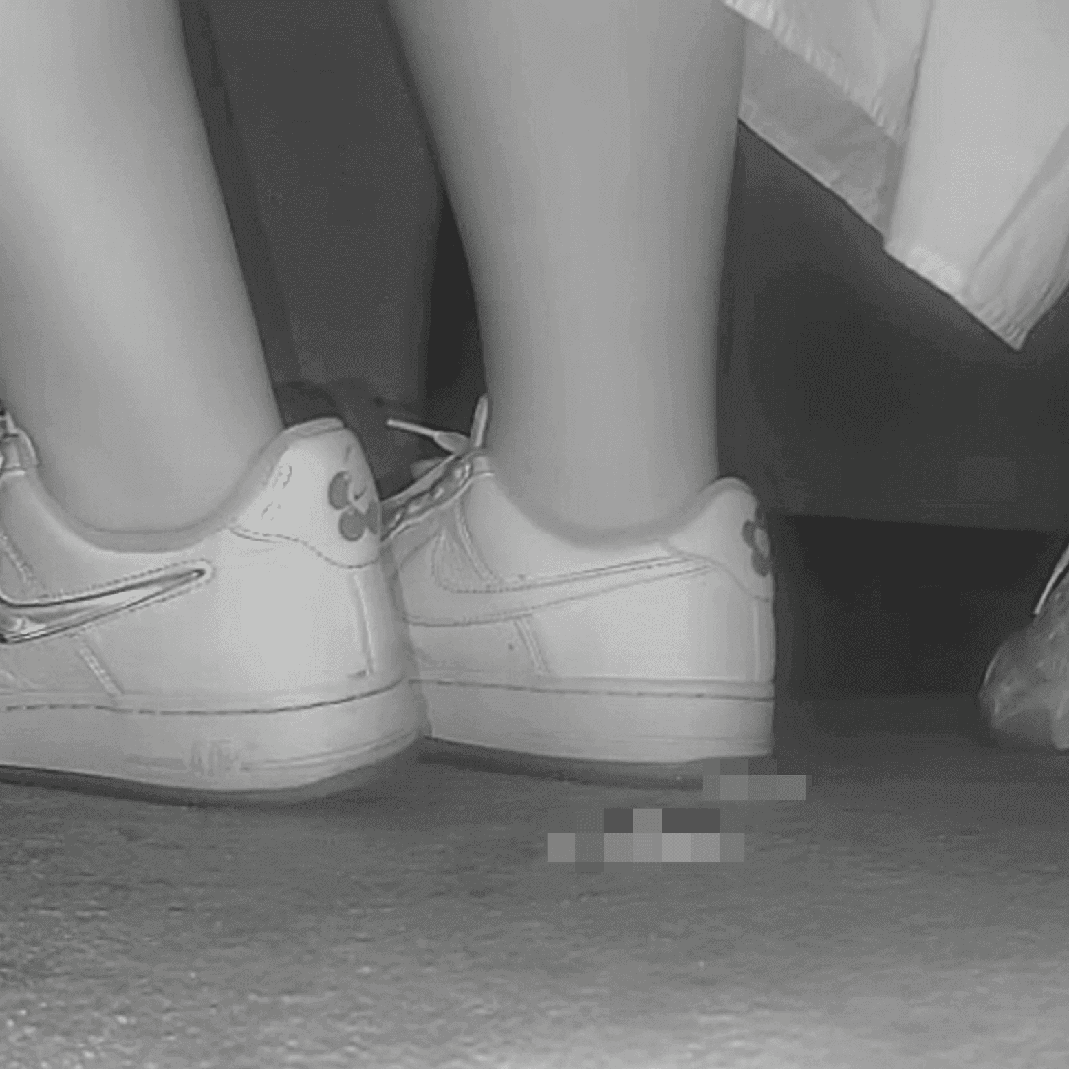 Woman in long dress candid crush with Nike sneakers at the cinema