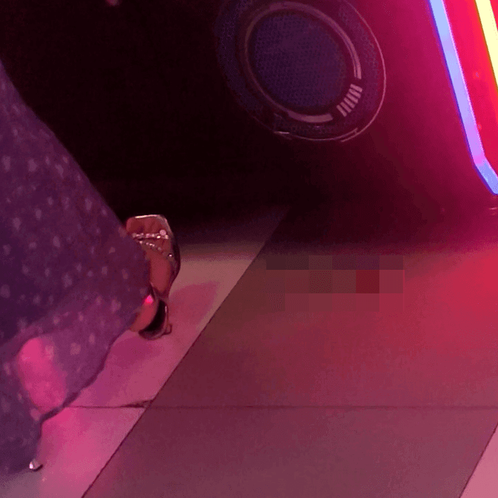 Game arcade woman candid crush with Converse shoes and stiletto heels while playing the basketball shooting machines