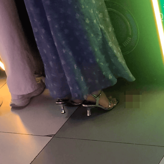 Game arcade woman candid crush with Converse shoes and stiletto heels while playing the basketball shooting machines