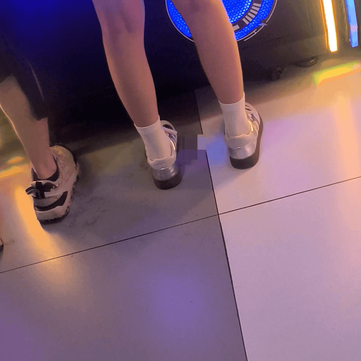 Game arcade lady in sneakers and leather shoes candid crush and stuck to soles