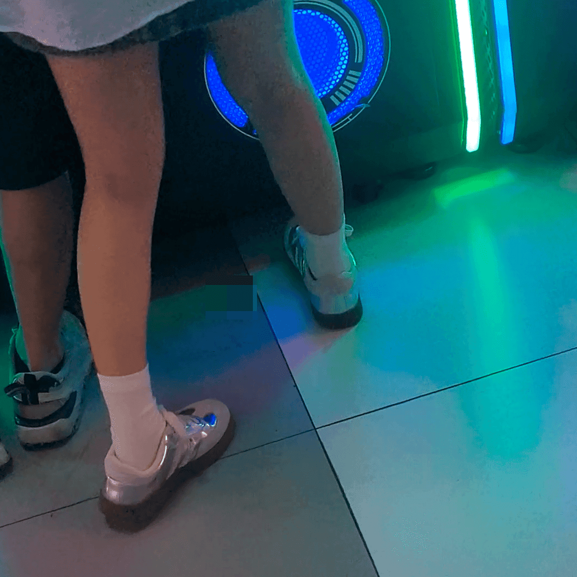 Game arcade lady in sneakers and leather shoes candid crush and stuck to soles