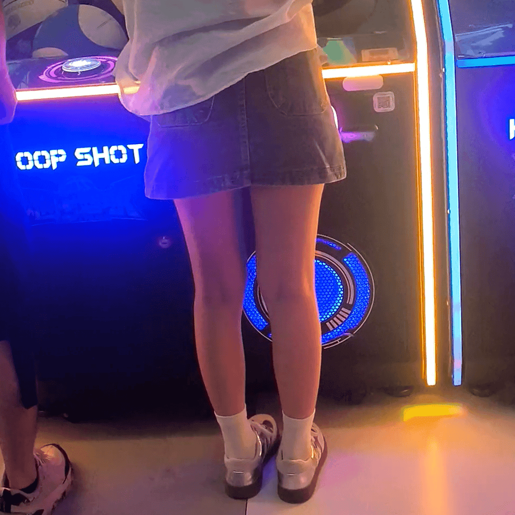 Game arcade lady in sneakers and leather shoes candid crush and stuck to soles
