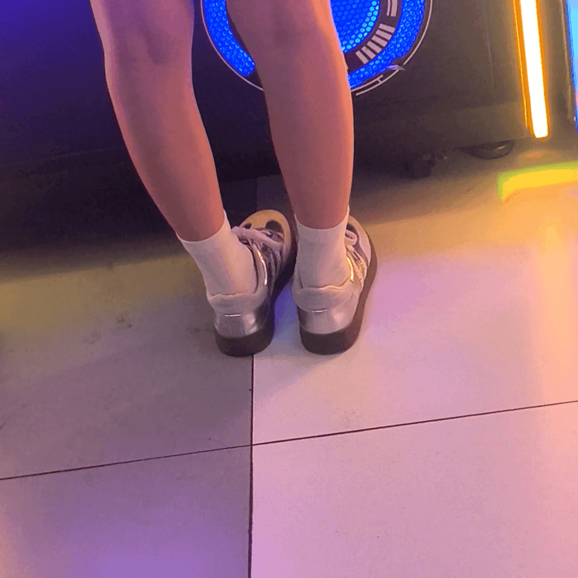 Game arcade lady in sneakers and leather shoes candid crush and stuck to soles