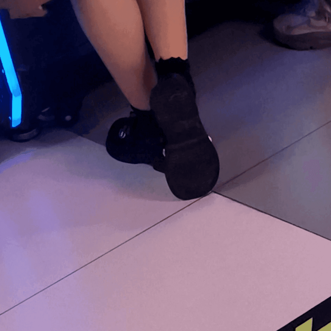 Game arcade lady in sandals and leather shoes candid crush and stuck to soles