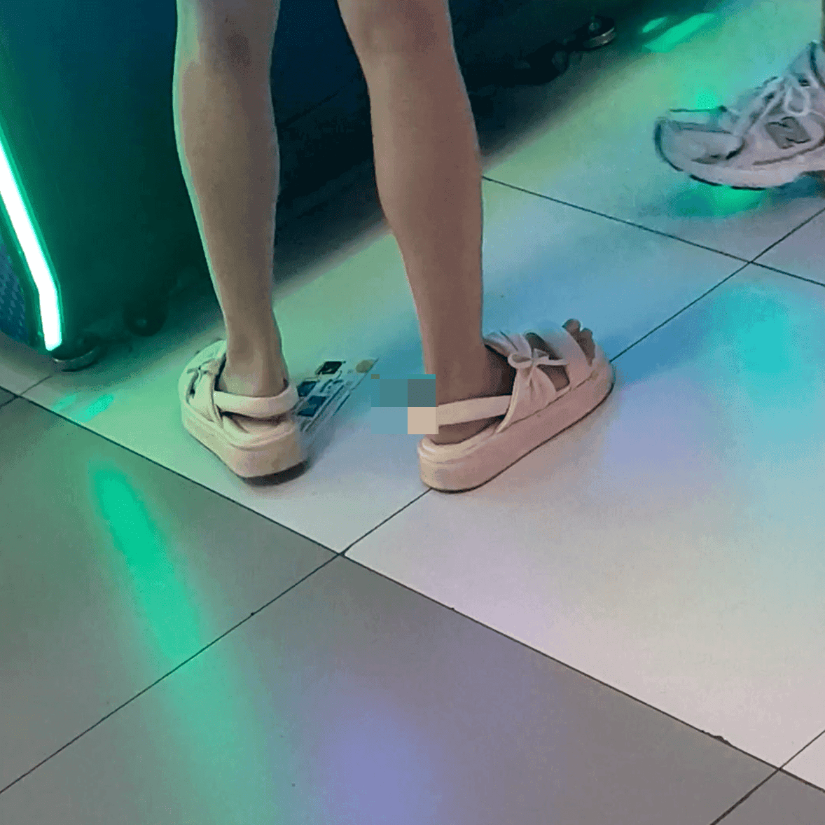 Game arcade lady in sandals and leather shoes candid crush and stuck to soles