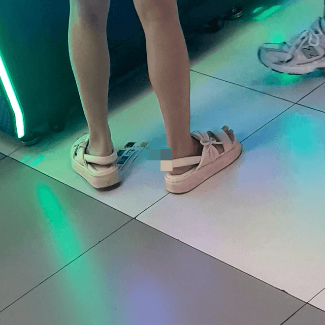 Game arcade lady in sandals and leather shoes candid crush and stuck to soles