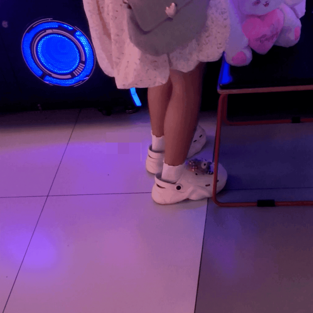 Game arcade young lady in sneakers candid crush and rub