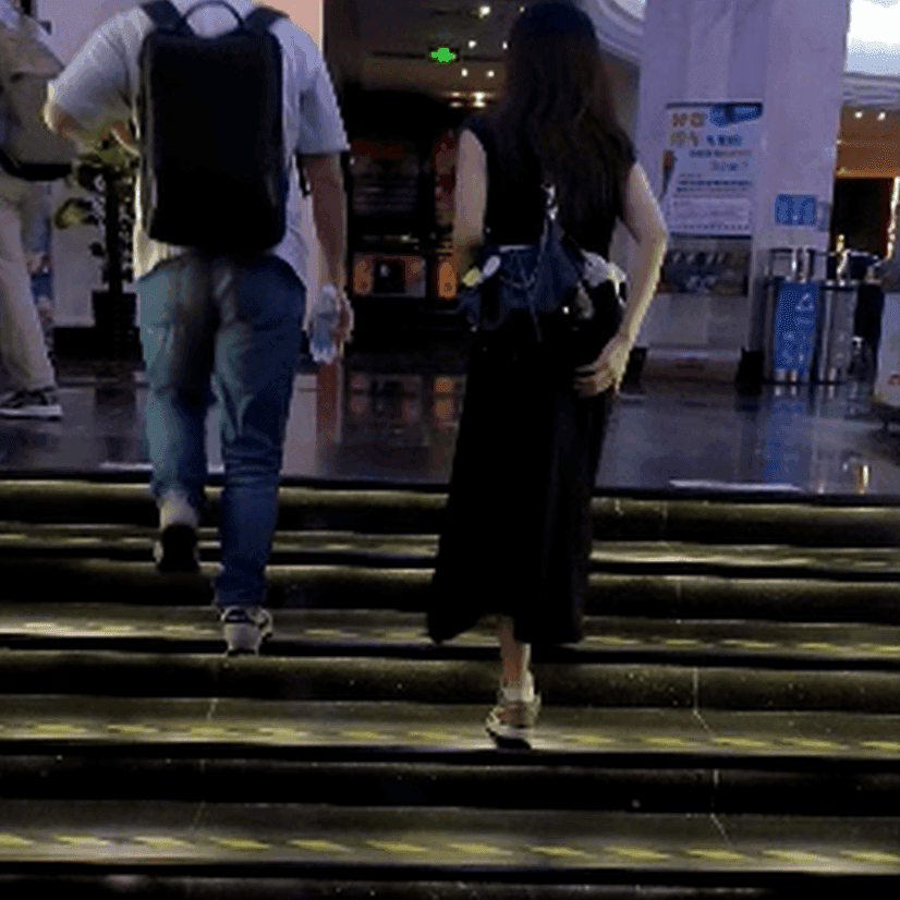 Woman in long dress candid crush with Air Jordan sneakers at the cinema