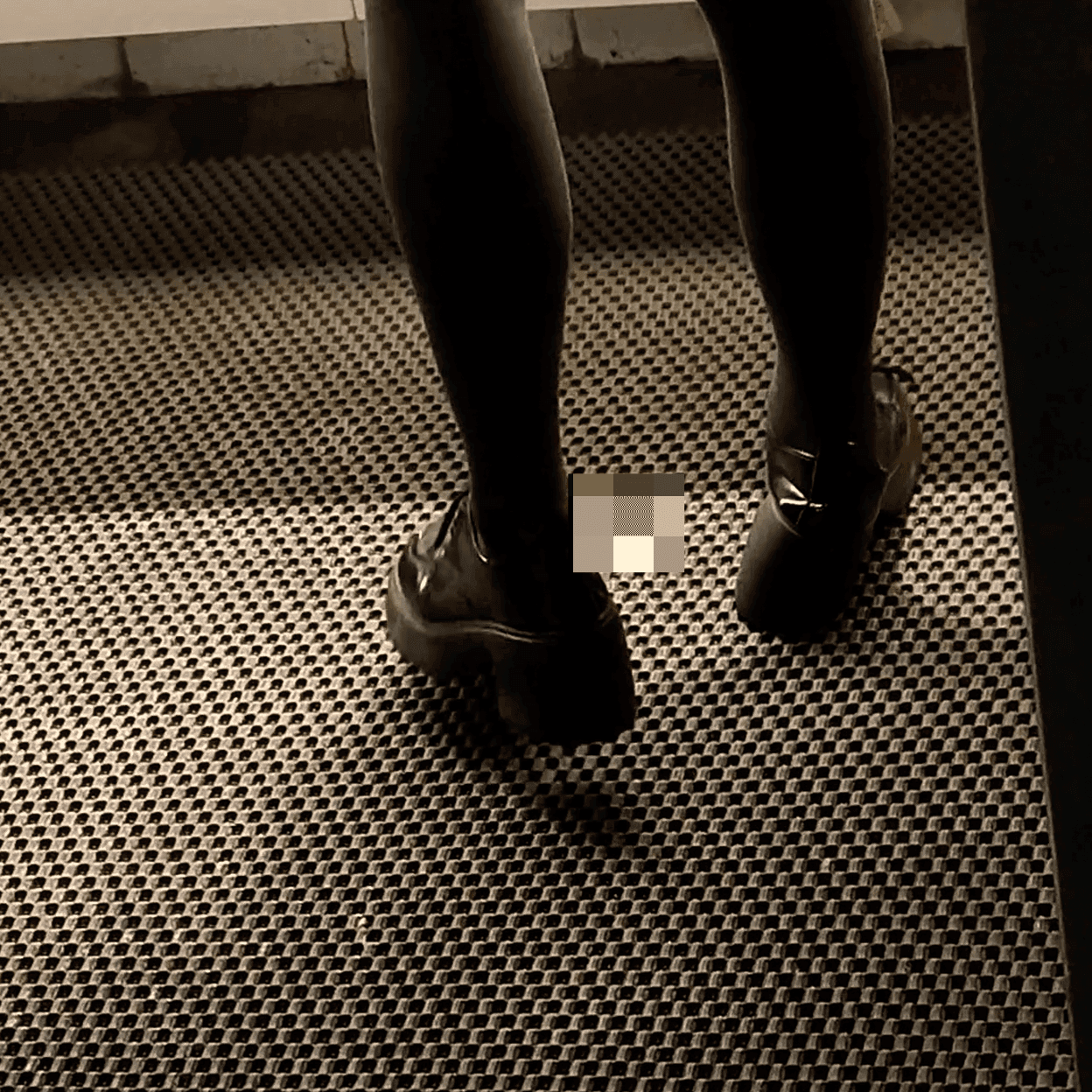 Woman in white socks and casual shoes candid crush repeatedly at the women's restroom entrance