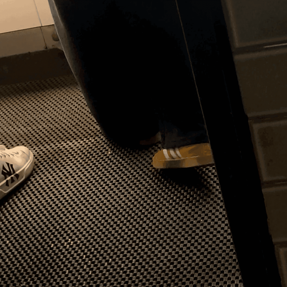 Multiple women in sneakers candid crush at the women's restroom entrance