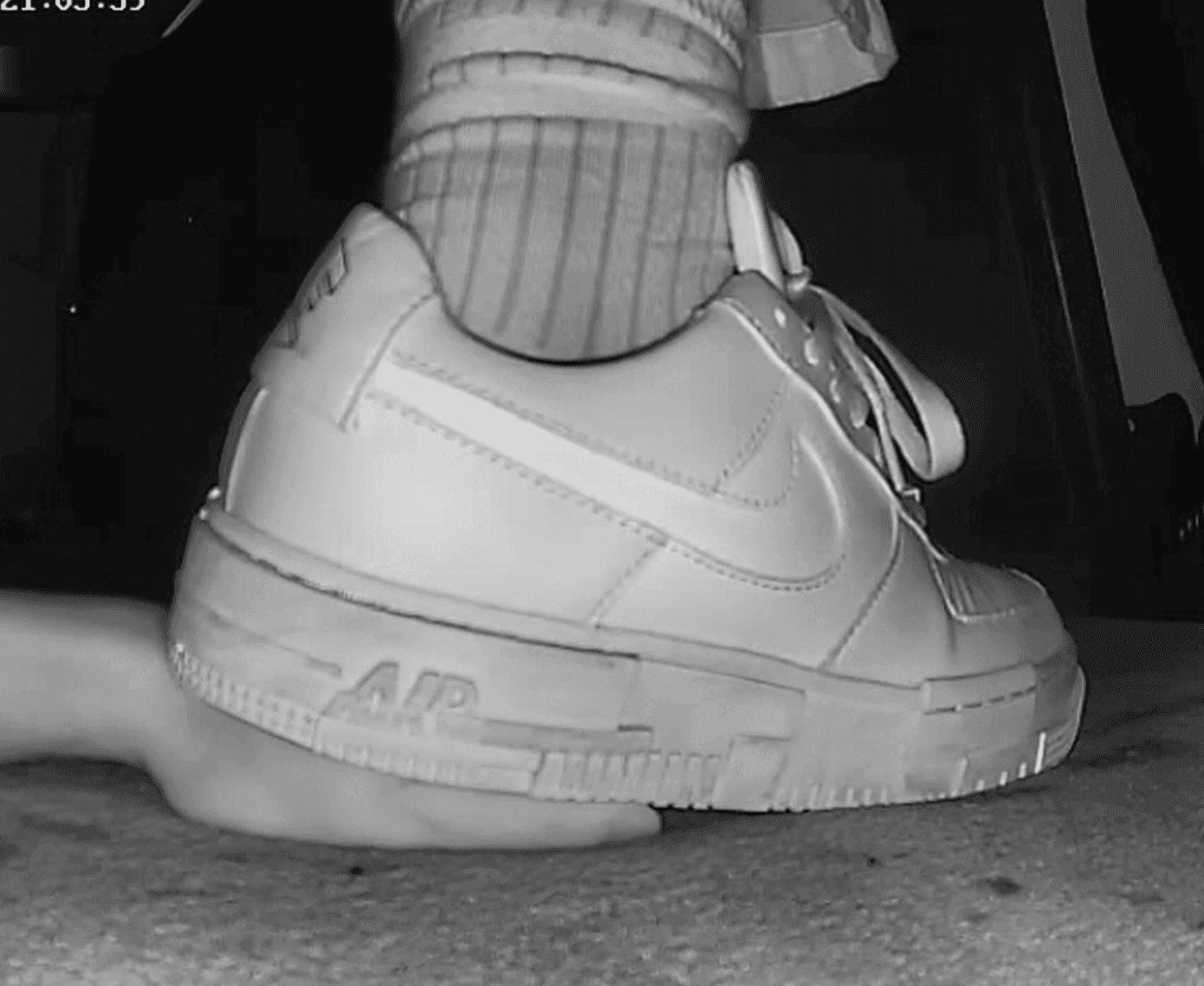 Cinema girl candid hard stepping on hand with Nike sneakers