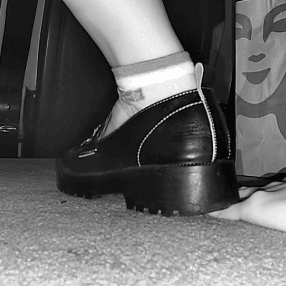 Cinema girl candid stepping on hand with leather shoes