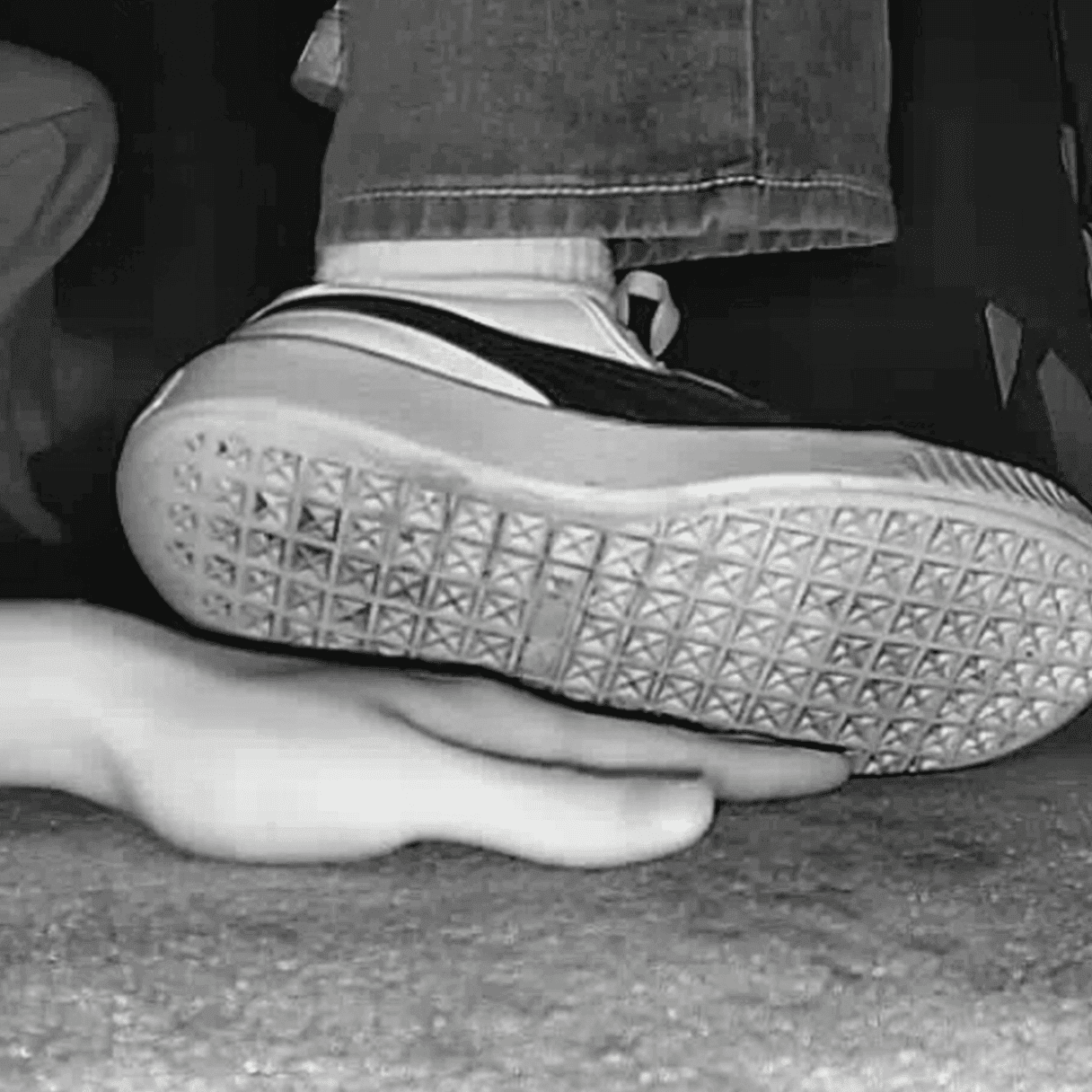 Girl candid hand trample with white socks Puma skate shoes in cinema