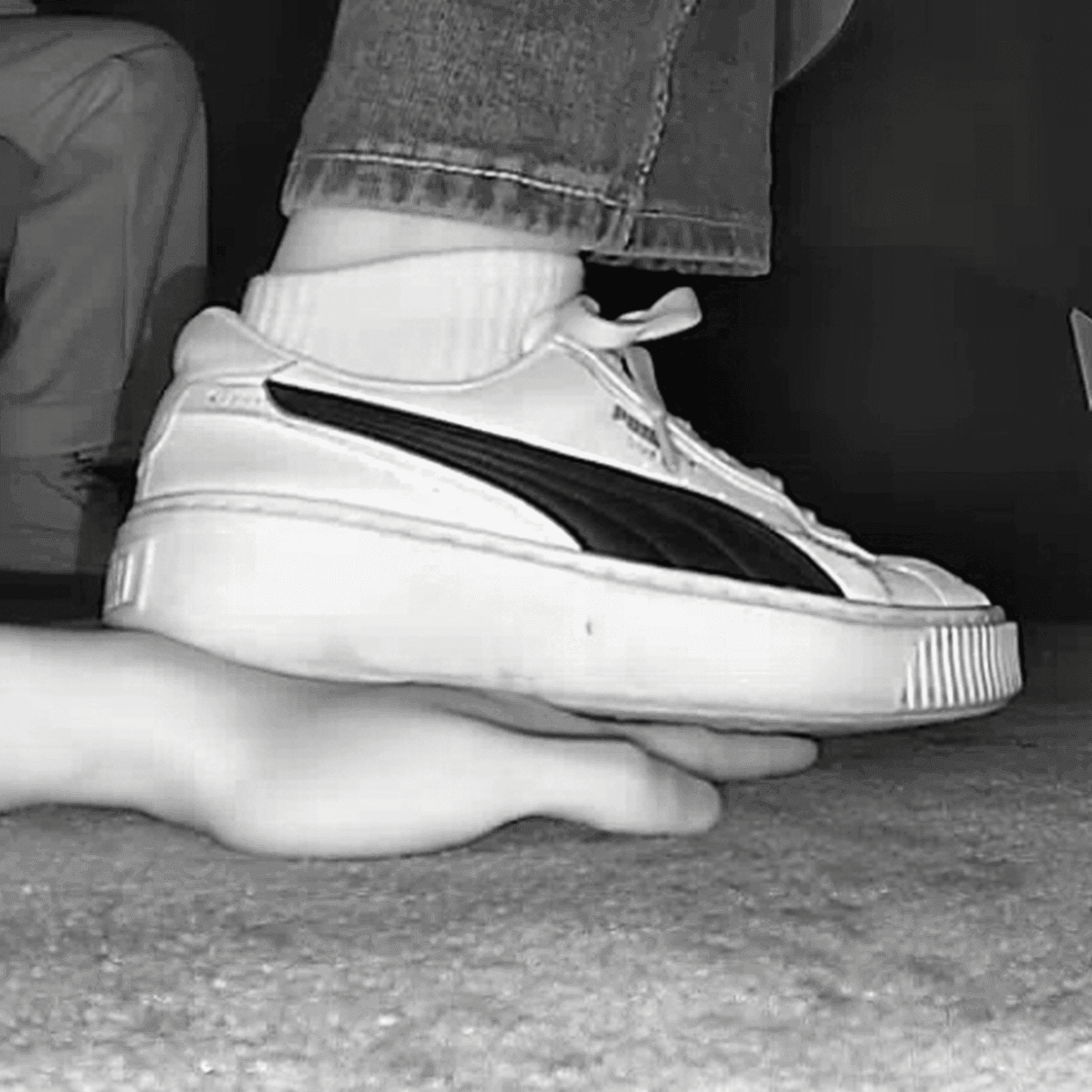 Girl candid hand trample with white socks Puma skate shoes in cinema
