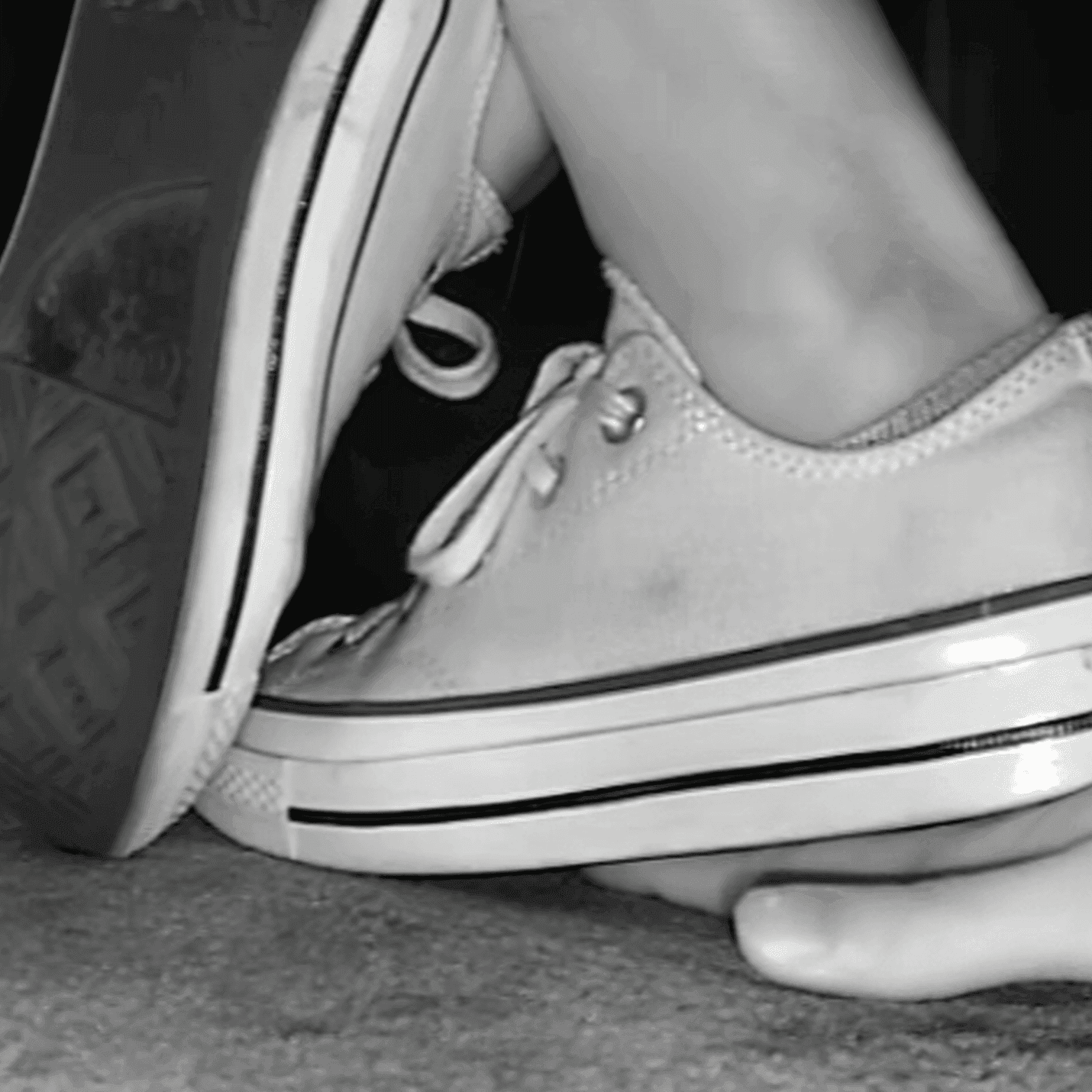 Girl in cinema wearing flat shoes + low-top Converse shoes candid trample hand