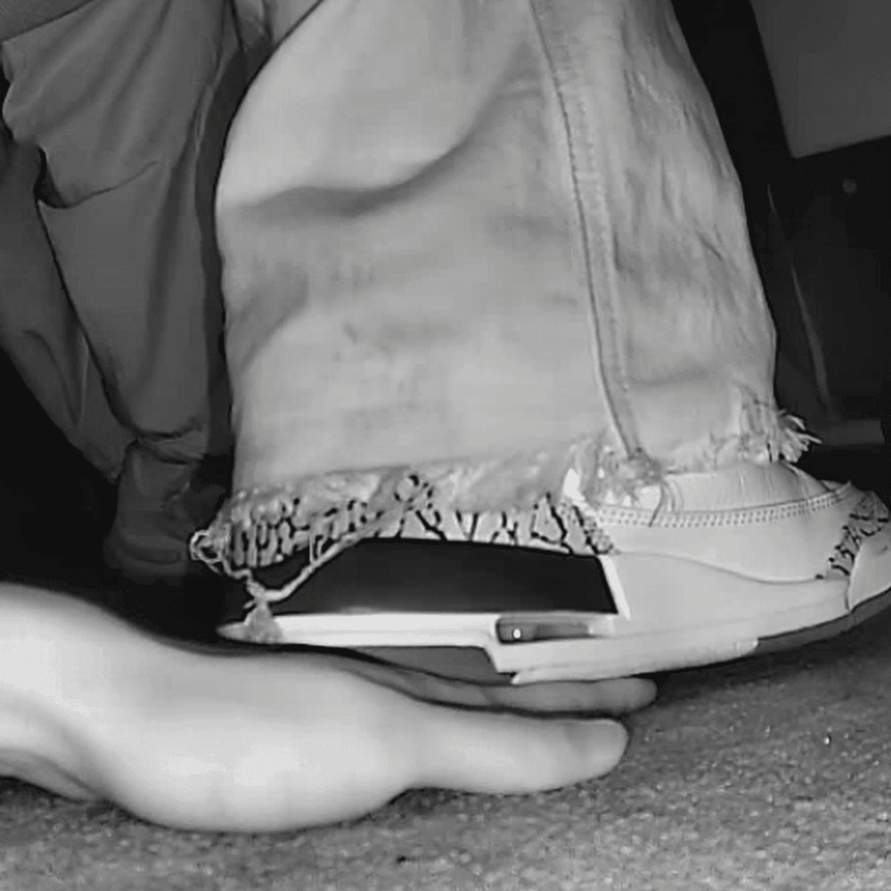 Girl in movie theater candid trample on hand with Nike Air Jordan sneakers