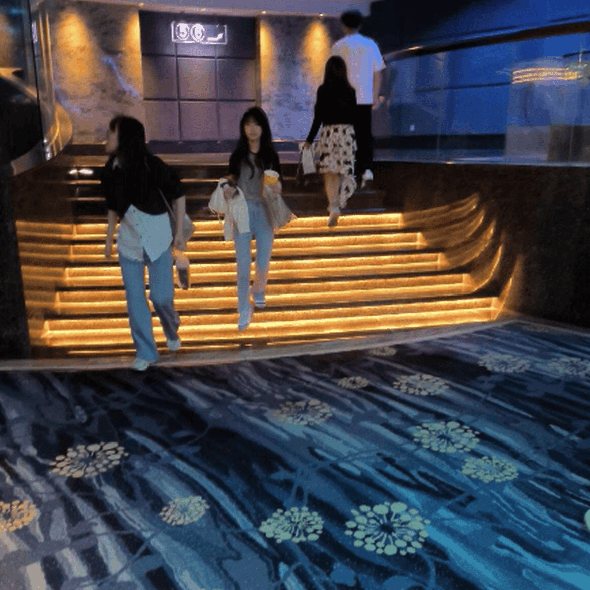 Girl in movie theater candid trample on hand with Nike Air Jordan sneakers