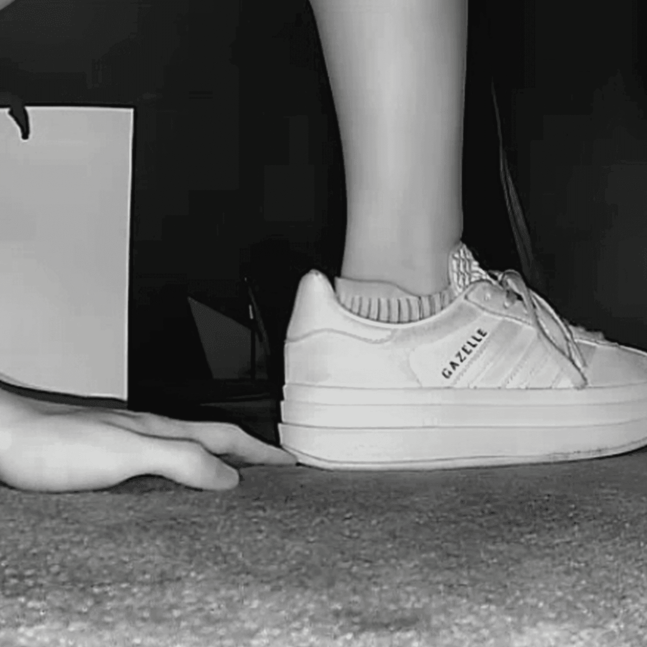 Girl in the cinema candid hand trample with sneakers and ankle boots
