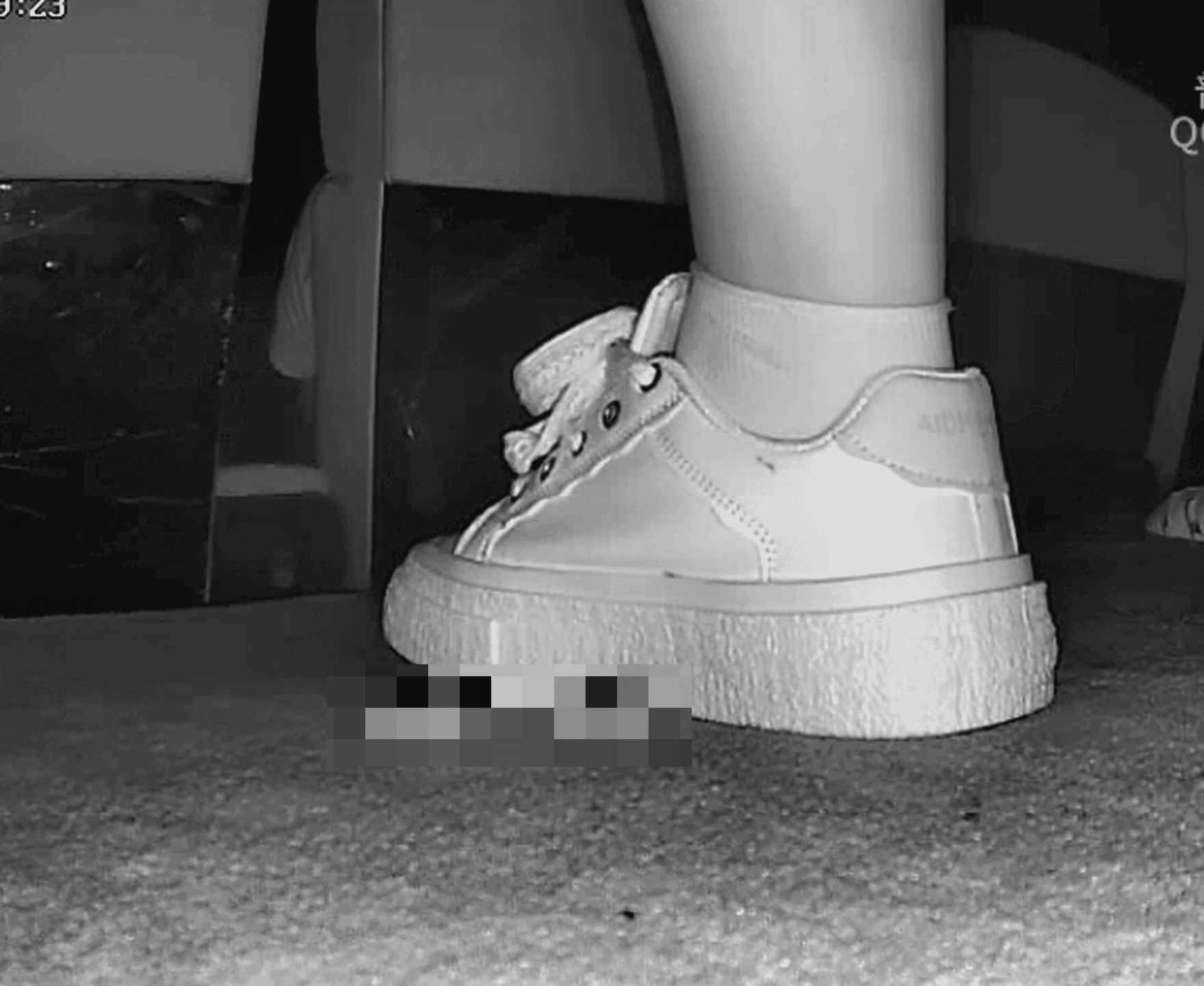 Woman in cinema candid crush with white sneakers