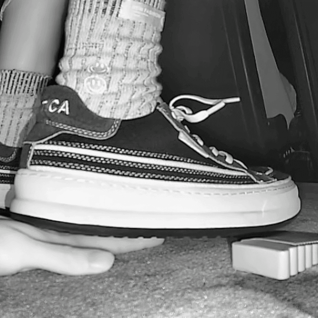 Girl in sneakers candid hand trample at cinema