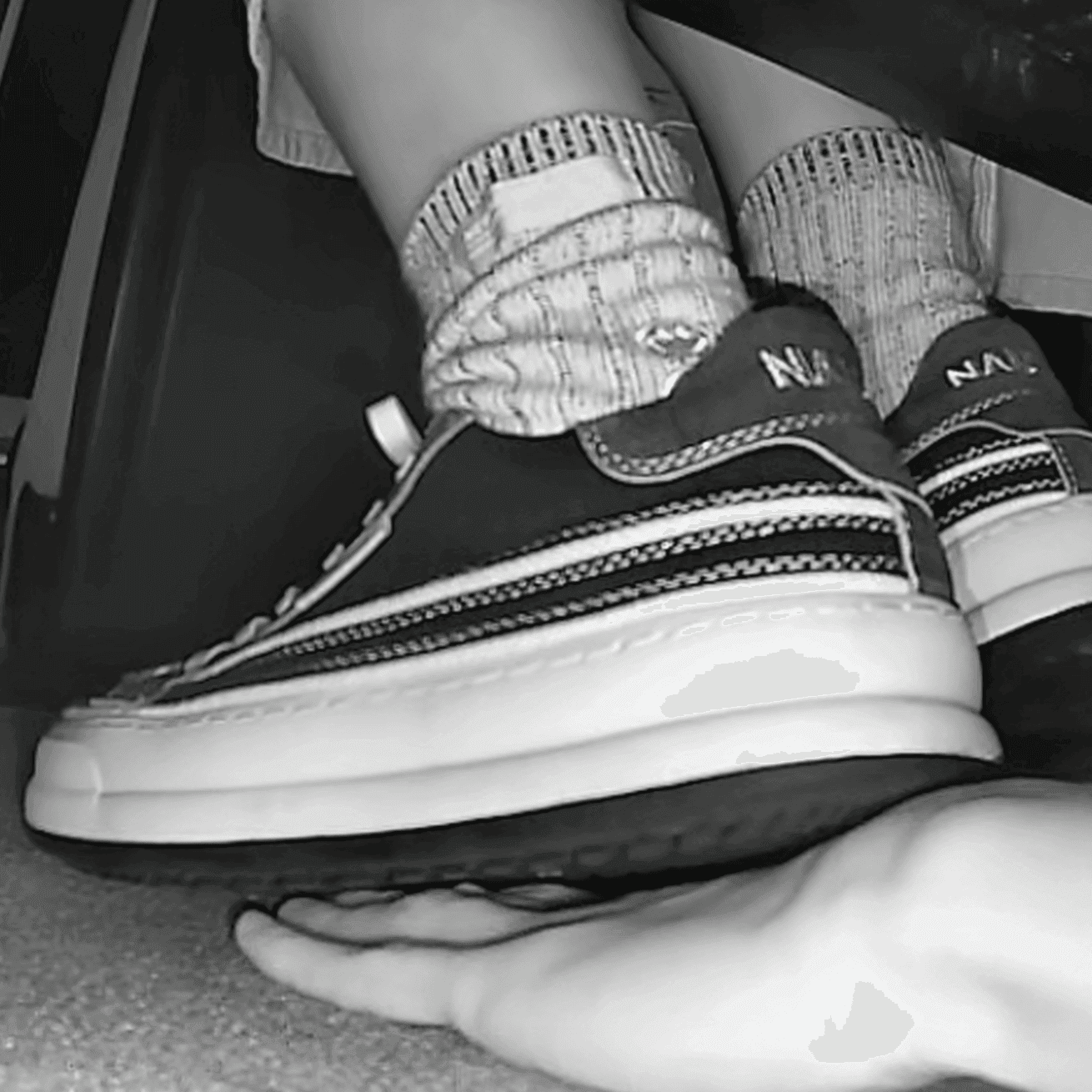 Girl in sneakers candid hand trample at cinema