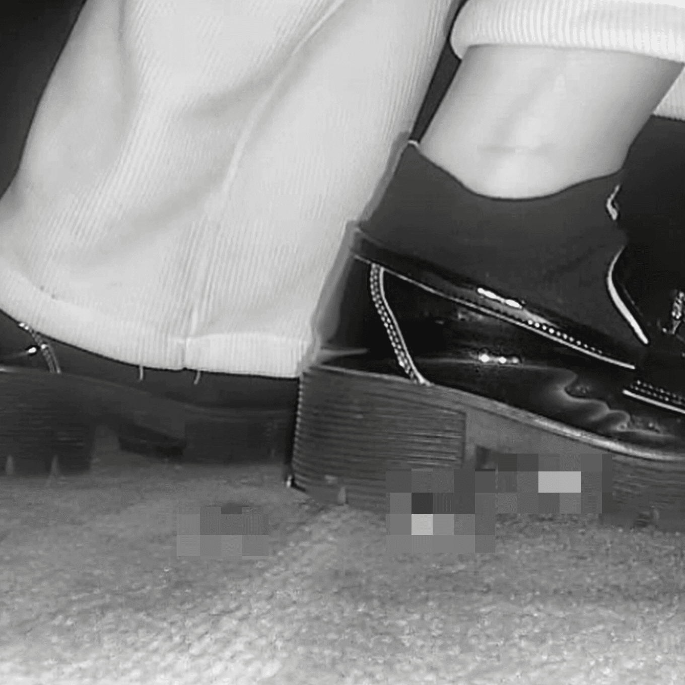 Woman candid crush with black leather shoes in cinema