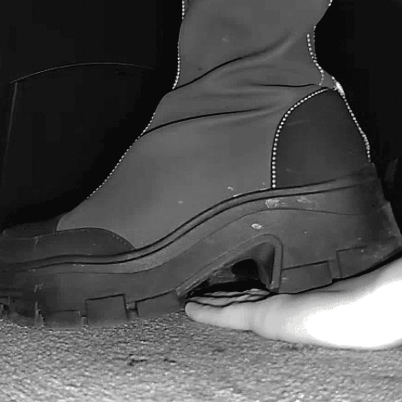 Woman at cinema candid hand trample with chunky-heeled knee-high boots