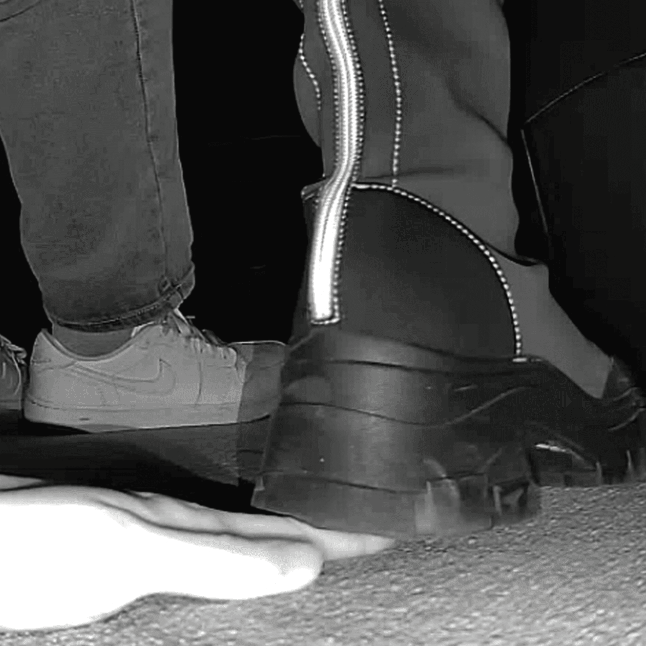 Woman at cinema candid hand trample with chunky-heeled knee-high boots