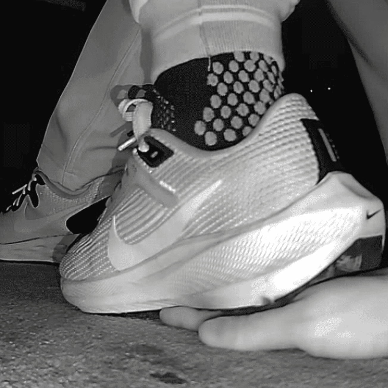 Cinema young girl candid hand trample with Nike running shoes