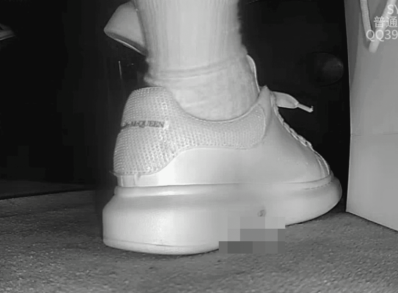 Woman candid crush with white socks and McQueen sneakers in cinema