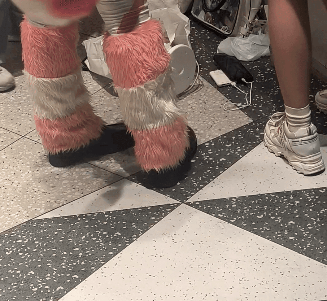 Woman in stockings and leather shoes candid crush at anime convention