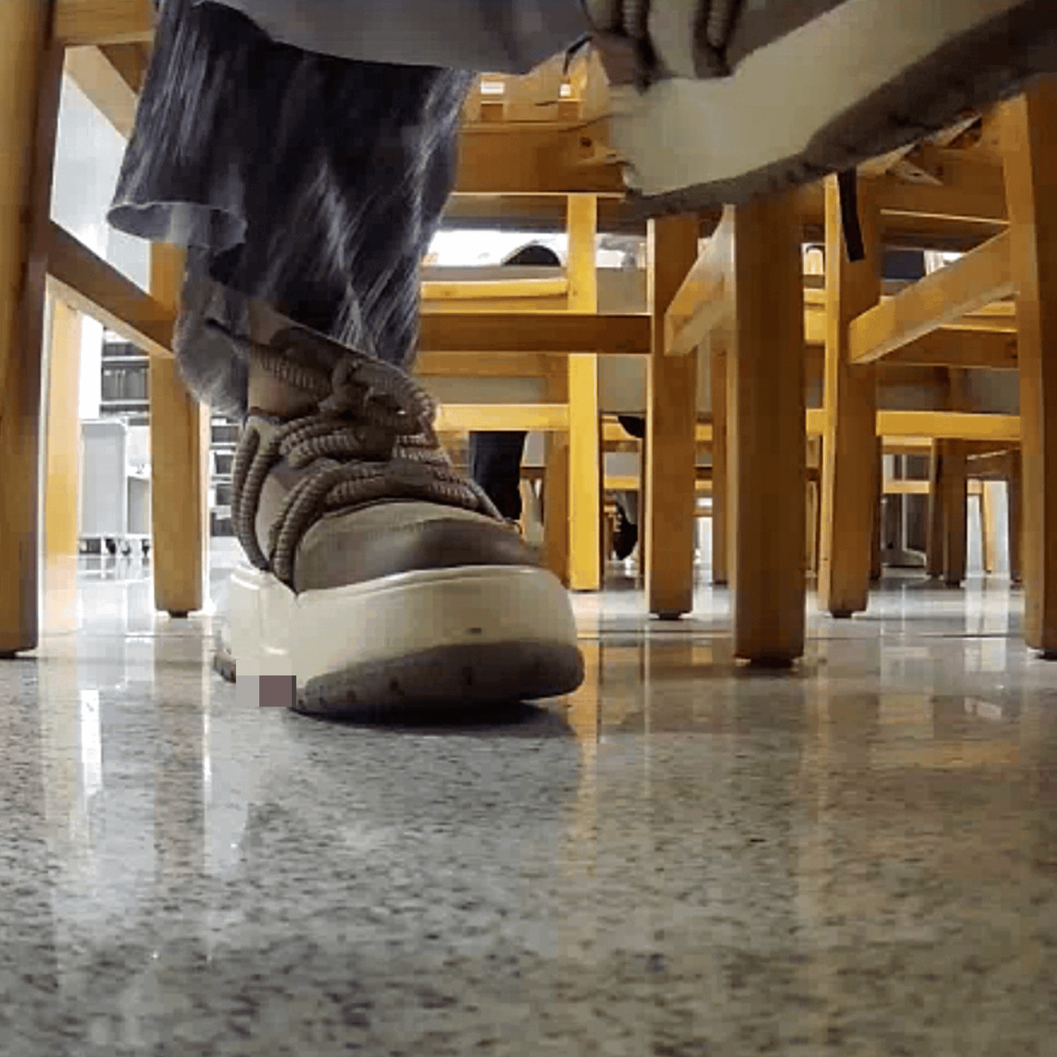 Woman at the library candid crush with the toe of her sneaker