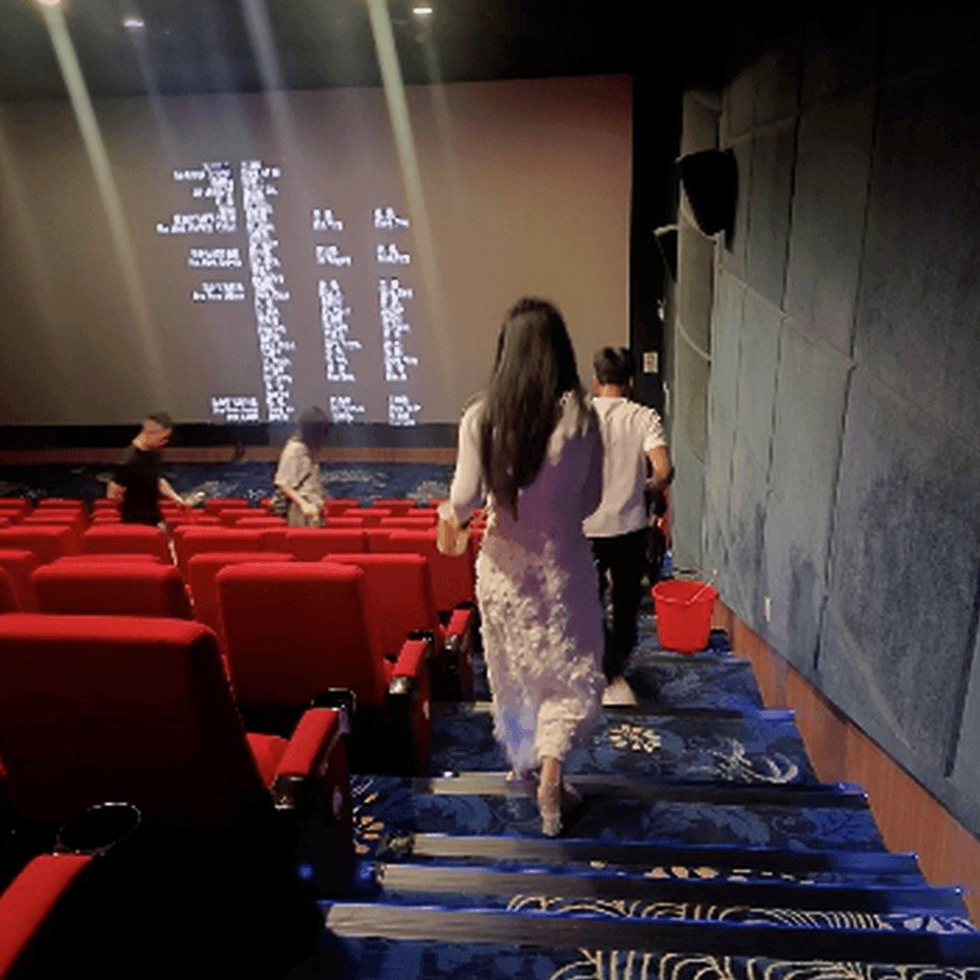 Woman in long dress candid crush with clear chunky heels at the cinema