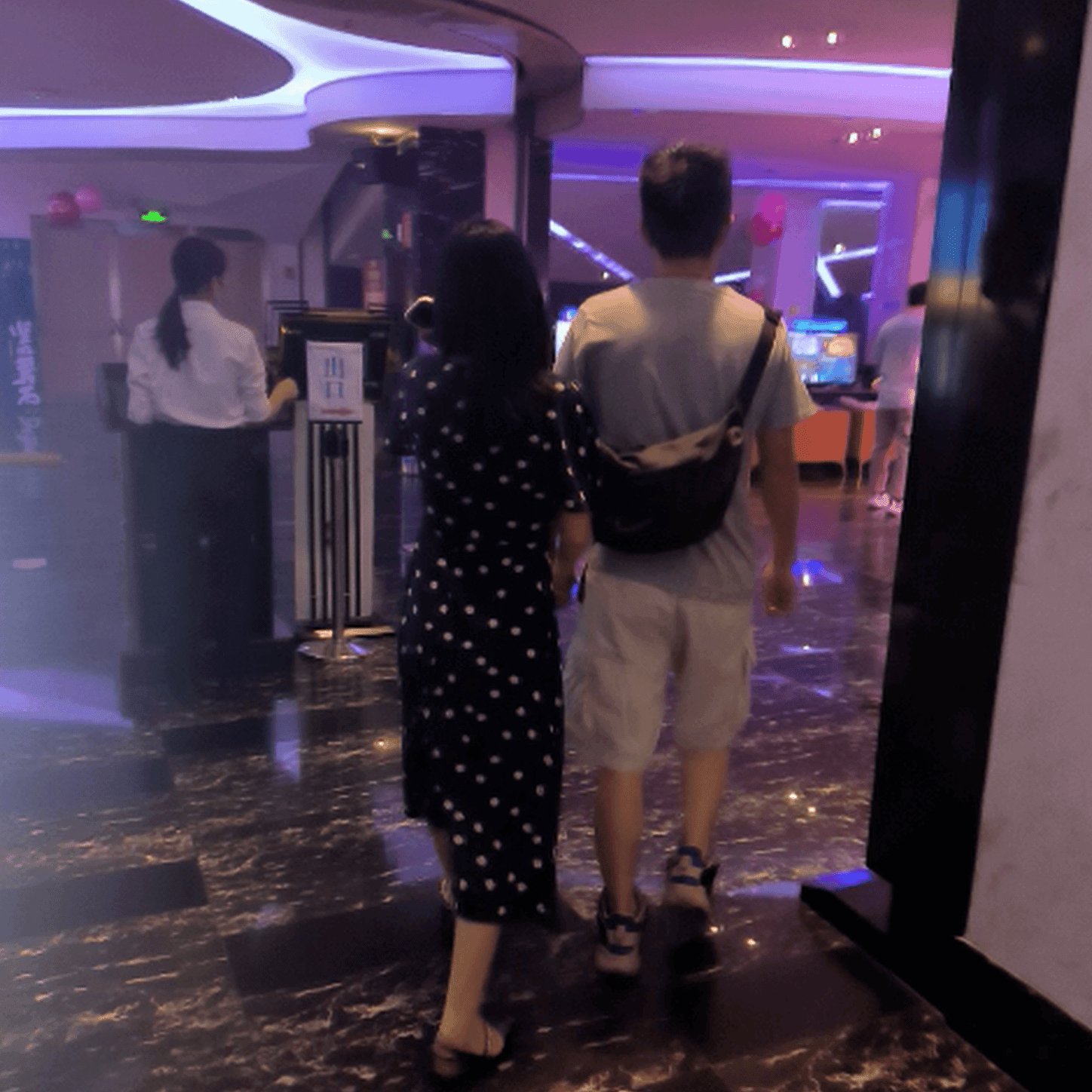 Cinema girl candid stepping on hand with black leather shoes + flat sandals