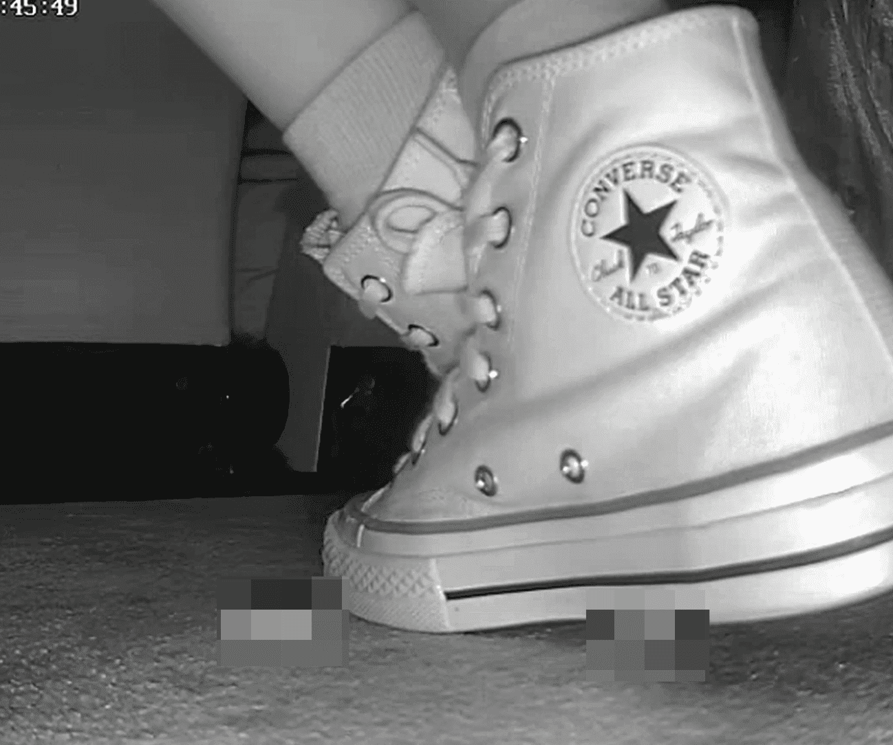 Woman candid crush with high-top white Converse at cinema
