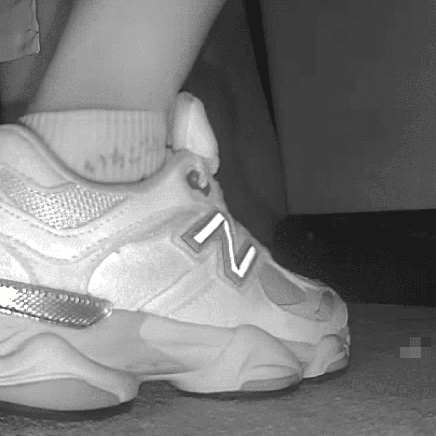 Woman sitting with her boyfriend candid crush with New Balance sneakers at cinema
