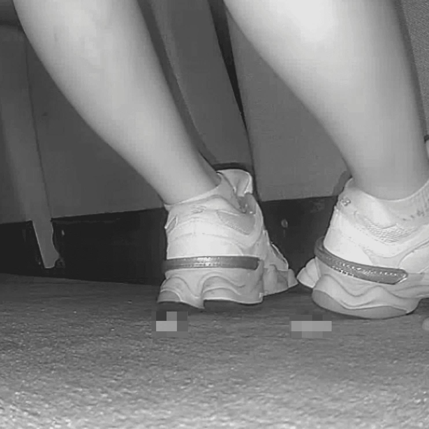 Woman sitting with her boyfriend candid crush with New Balance sneakers at cinema