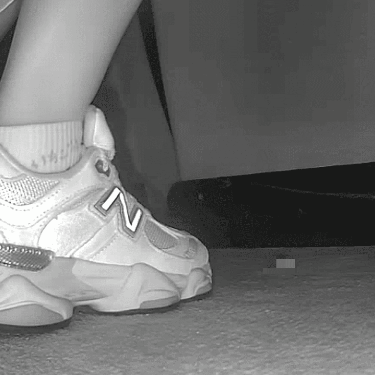 Woman sitting with her boyfriend candid crush with New Balance sneakers at cinema