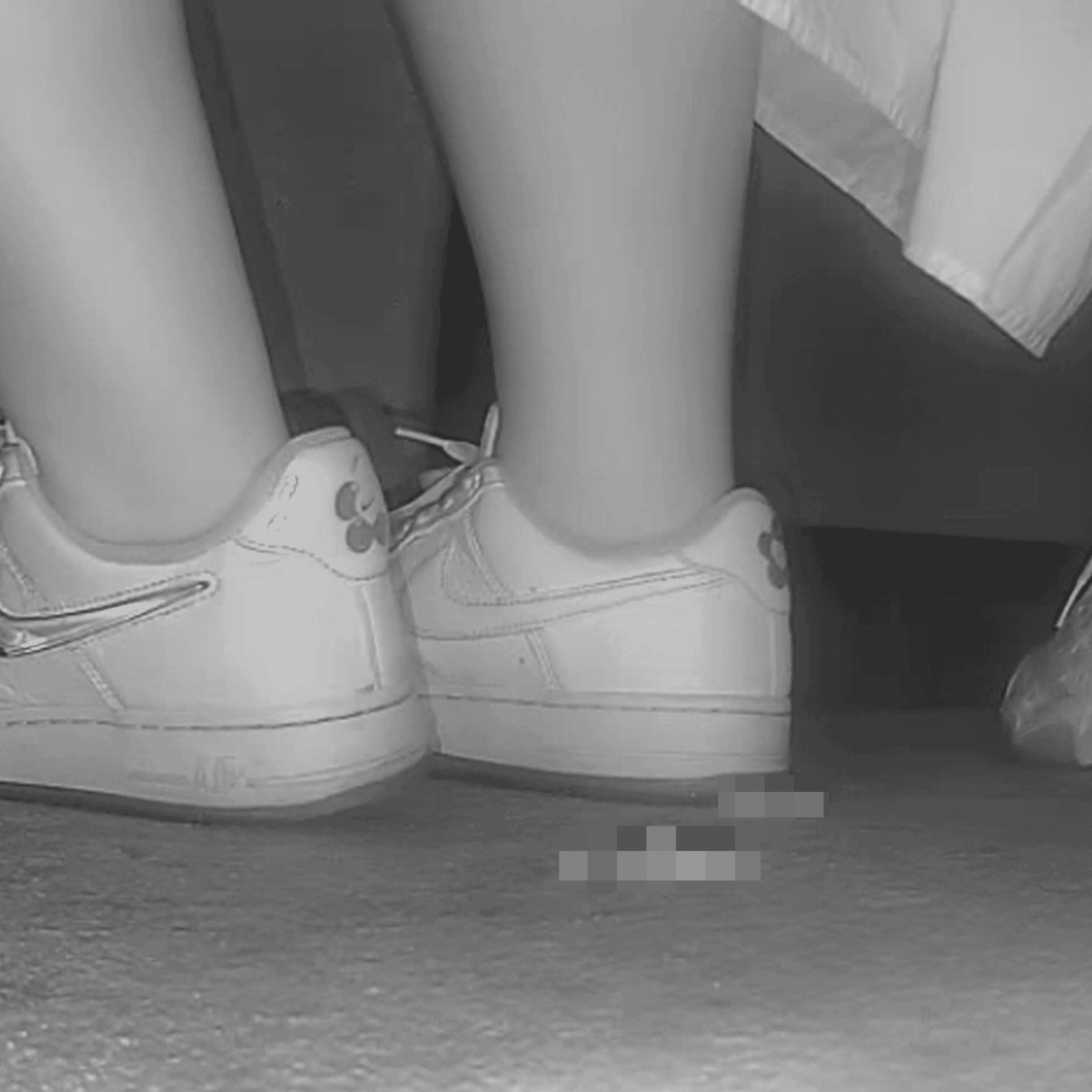 Woman in long dress candid crush with Nike sneakers at the cinema