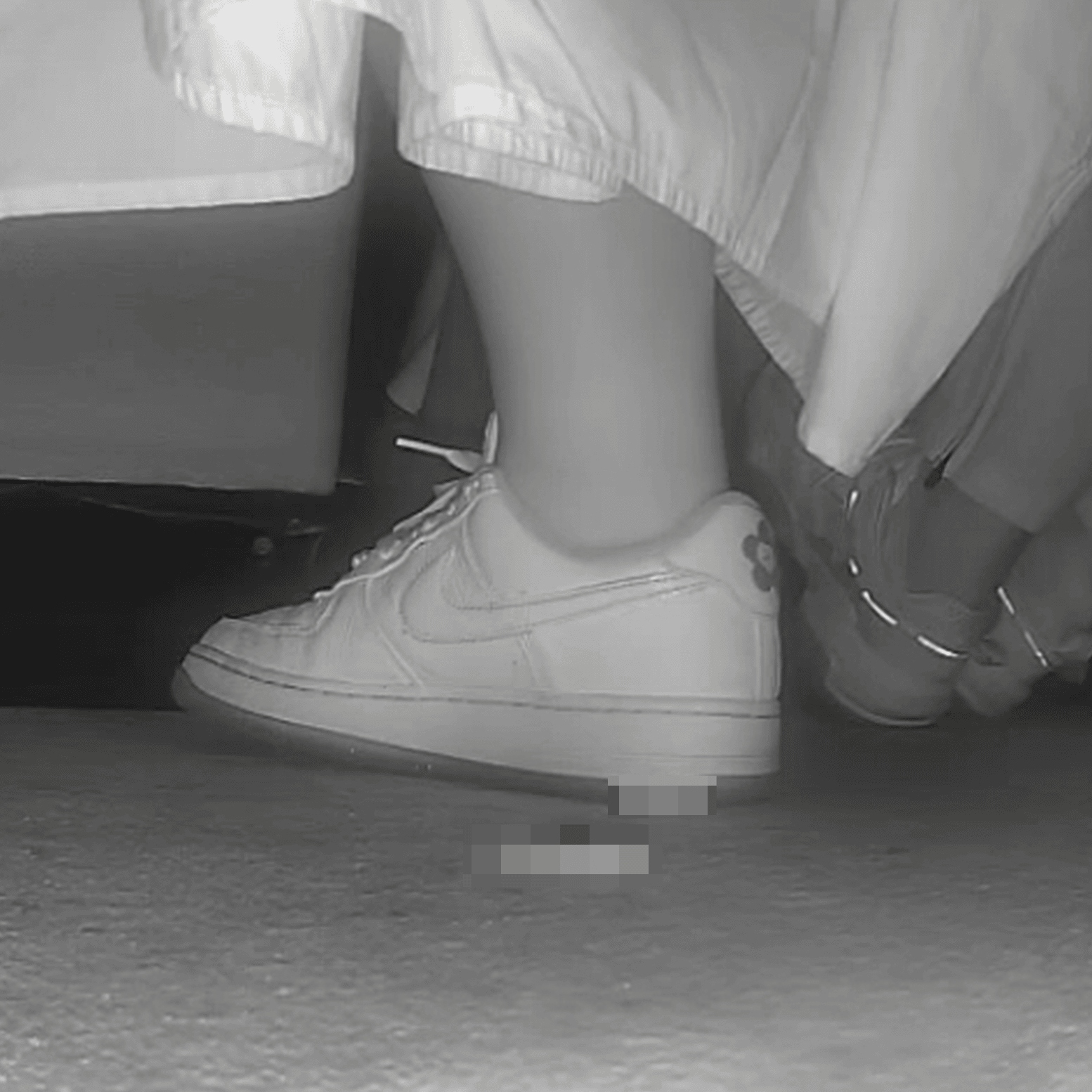 Woman in long dress candid crush with Nike sneakers at the cinema