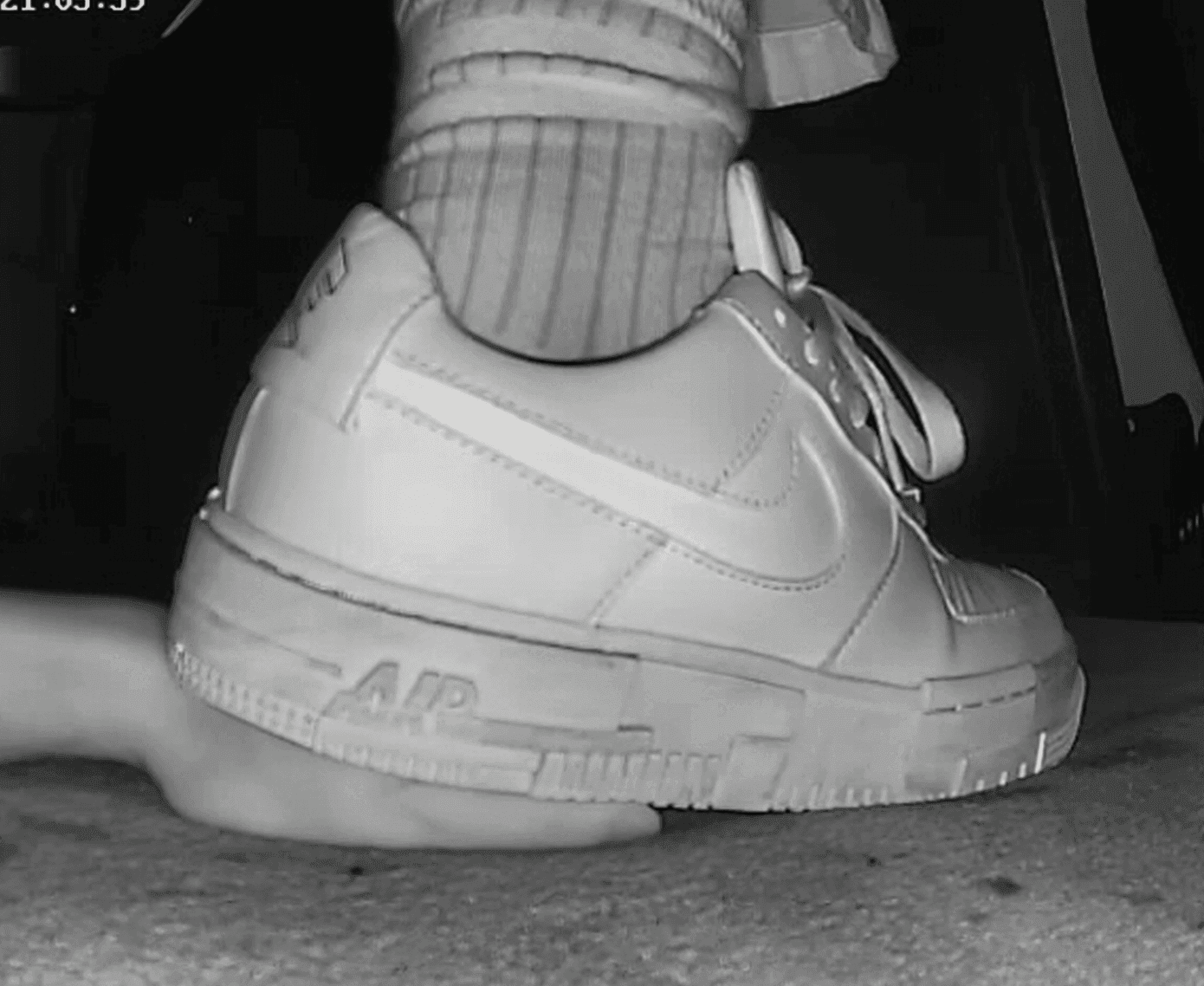 Cinema girl candid hard stepping on hand with Nike sneakers